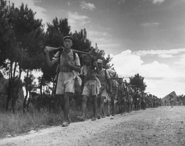 ֣Chinese foot soldiers, wearing straw sandals, marching along road..jpg