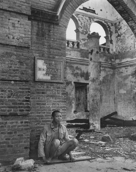 ֣Chinese refugee squatting in front of Baptist Church which is totally de.jpg